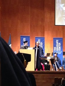 Davis in navy blue doctoral robes, on the stage at Avery Fisher Hall.