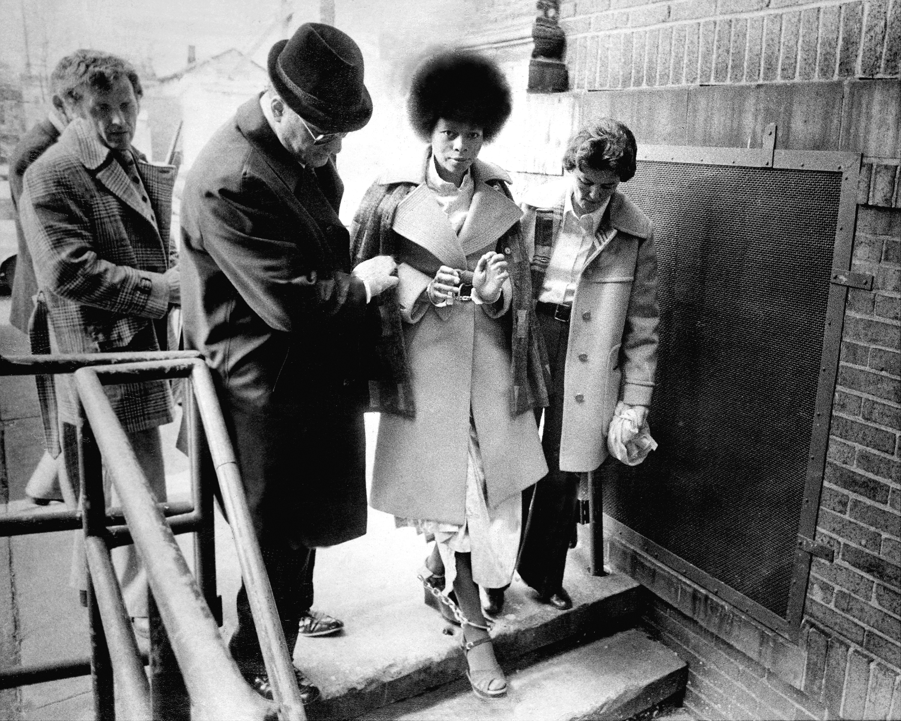 UNITED STATES - JANUARY 29: In a caravan of eight cars bearing heavily armed state police and county officers, JoAnne Chesimard, the reputed "soul" of the Black Liberation Army, was taken chained handcuffs and leg irons from Riker's Island prison in New York City ot the Middlesex County jail to await trail in the murder of state trooper Werner Foerster. (Photo by Frank Hurley/NY Daily News Archive via Getty Images)