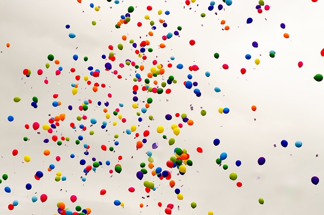 many colorful balloons on a white background